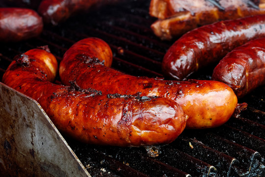 Bratwurst sausages on cast iron griddle.