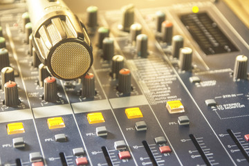 Fototapeta na wymiar Microphones on mixers, recording devices, multimedia production tools.