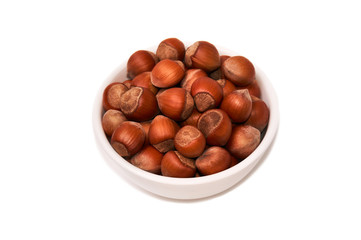 Nuts in a white bowl isolated on white background, top view