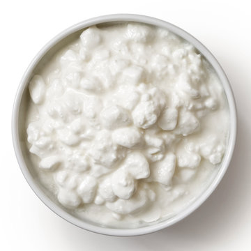 White ceramic bowl of chunky cottage cheese isolated on white from above.