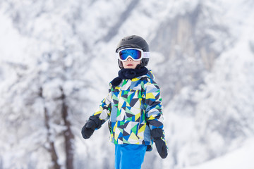 Fototapeta na wymiar Cute preschool child, boy, skiing happily in Austrian ski resort
