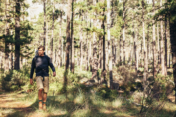 Man with a backpack walking in forest
