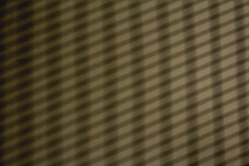 Shadow from the window on the cement wall.