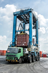 Crane with container and truck
