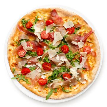Prosciutto pizza with cherry tomatoes and rucola isolated on white from above.