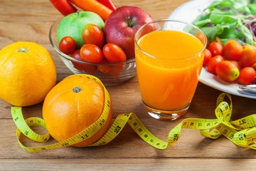 Healthy concept with mixed fruits and vegetables on wooden background