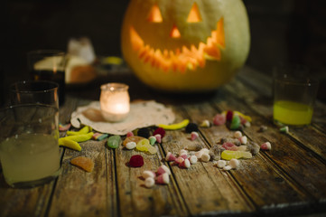 Sweets and drink next to the pumpkin, halloween.