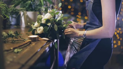 Close-up. florist making bouquet at flower shop