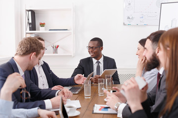 Business corporate meeting of young successful team with african american male boss.