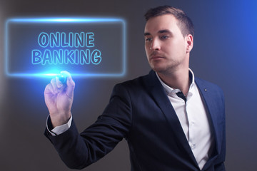 The concept of business, technology, the Internet and the network. Young businessman showing inscription: Online banking