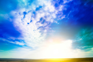 Sky. Blue sky background with purple and green clouds. Sky with clouds on sunset