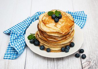 Plate with pancakes and blueberries