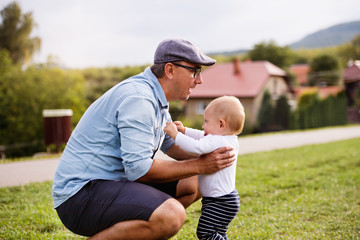 Father and little boy in nature in summer.
