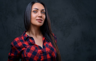 A woman dressed in a red fleece shirt over grey background.