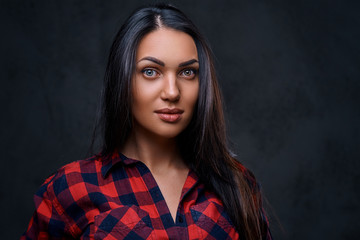A woman dressed in a red fleece shirt over grey background.