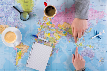Couple planning trip to Indonesia, point on map