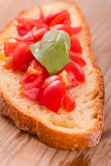 Bruschetta bread with basil and chopped tomatoes. 