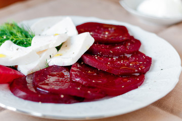 Beet root salad with feta cheese on white background