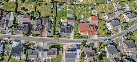 row of houses on a street in Germany, detached houses with gardens, aerial photo