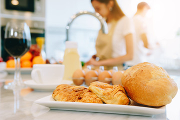 Asian teen couple are helping to make dinner. And bakery together happily. On Valentine's Day in their home.
