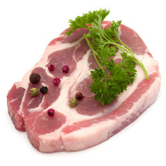 Raw pork neck chop meat with parsley herb leaves and peppercorn spices garnish isolated on white background cutout