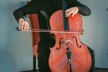 Man sitting on chair and plating cello © Nejron Photo