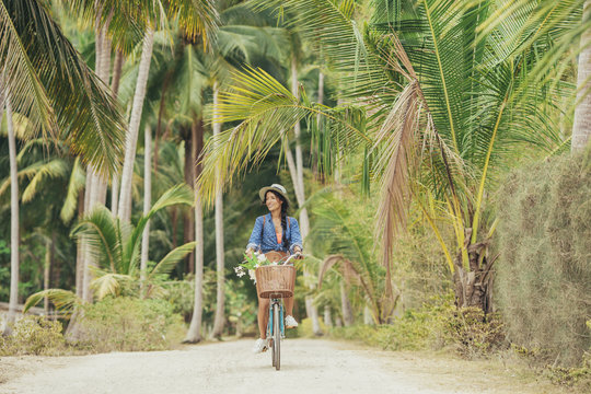 Woman Riding a Bike on a Tropical Island