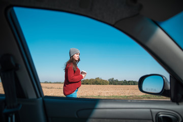 woman opening car door on highway
