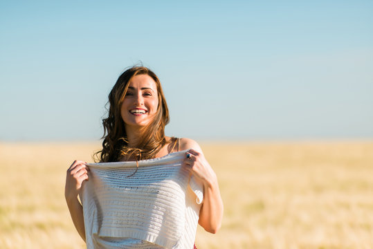 woman undressing on the barley field