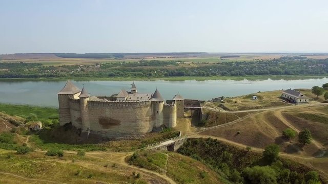 Aerial view of Khotyn medieval castle on the green hill above the river.