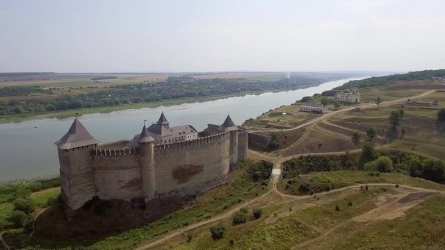 Aerial view of Khotyn medieval castle on the green hill above the river.