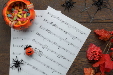 Top view of  Happy Halloween Festival and music note sheet background concept.Trick or treat bowl...