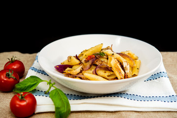 Pasta with pesto sauce and nuts on a the table