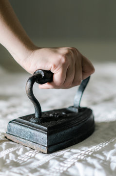 antique iron removing wrinkles from shirt