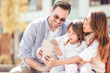 Young and happy family with a daughter taking a selfie.