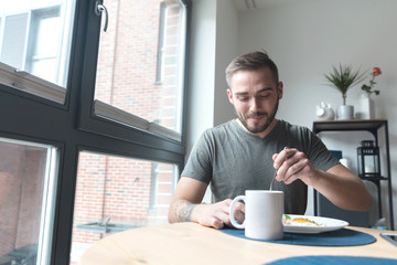 Man eating breakfast in the morning - Powered by Adobe