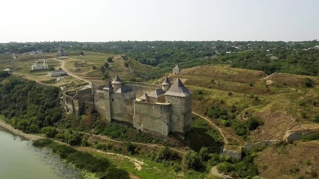 Aerial view of Khotyn medieval castle on the green hill above the river.