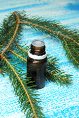 Essential oil and sprig of pine