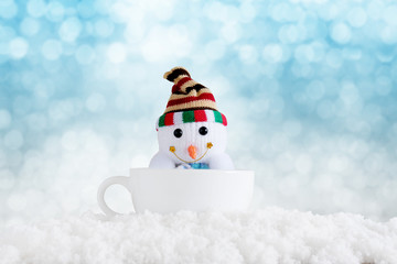 Merry christmas and happy new year background. Snowman in cup with winter background.