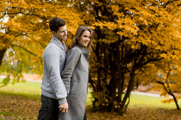 Lovely young couple in the autumn forest