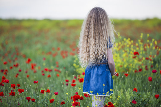 Girl in a field of poppies