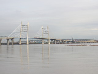 Fototapeta premium Cable-stayed bridge over the big river in the evening