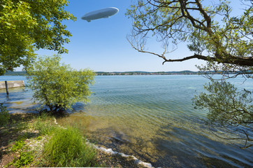 The waterside near Niederzell on the island Reichenau with zeppelin - Island of Reichenau, Lake Constance, Baden-Wuerttemberg, Germany, Europe © karlo54