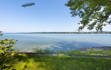 The waterside near Niederzell on the island Reichenau with zeppelin - Island of Reichenau, Lake Constance, Baden-Wuerttemberg, Germany, Europe © karlo54