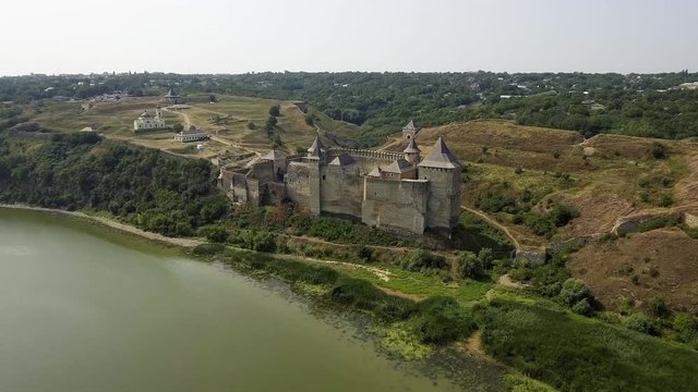 Aerial view of Khotyn medieval castle on the green hill above the river.