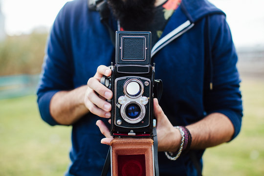 Someone holding a vintage camera