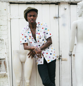 Tattooed black man with mannekins