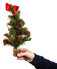 small decorative Christmas tree in a woman's hand. Isolated on white background