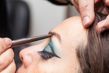 Make up artist applying makeup on eyebrows