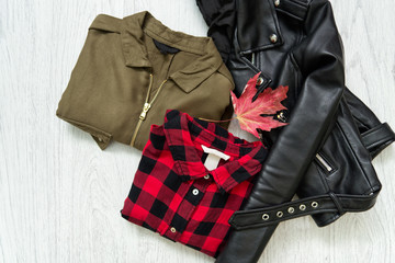 Khaki and red checkered shirt, black jacket and maple leaf. Fashionable concept